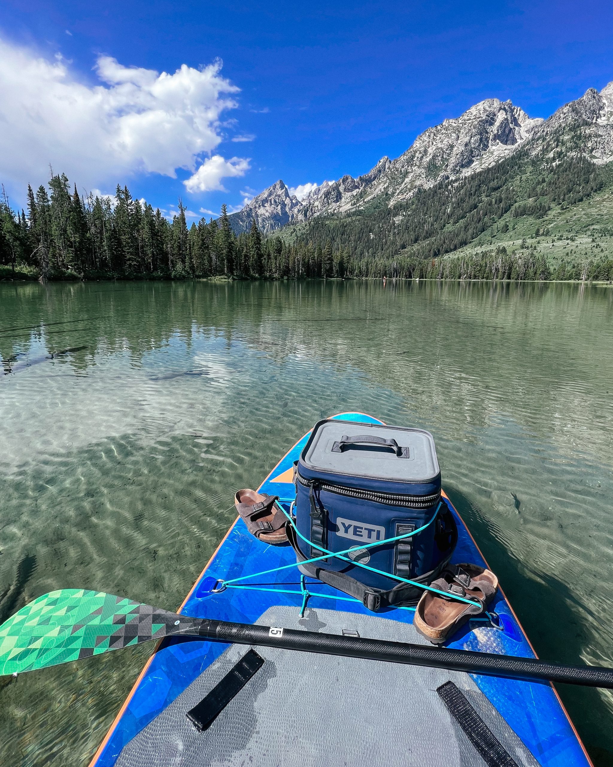 paddle boarding in grand teton national park after hiking