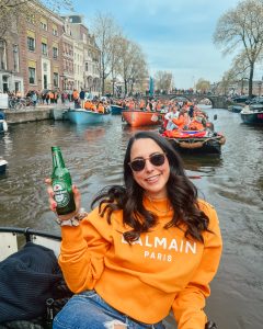 woman Kings Day Amsterdam canal boat champagne orange Heineken beer